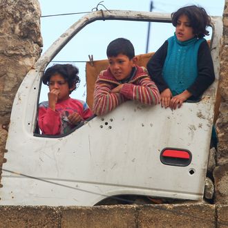 Aleppo,,Syria-february,15,,2012:,Children,Looking,Through,The,Shattered,Car